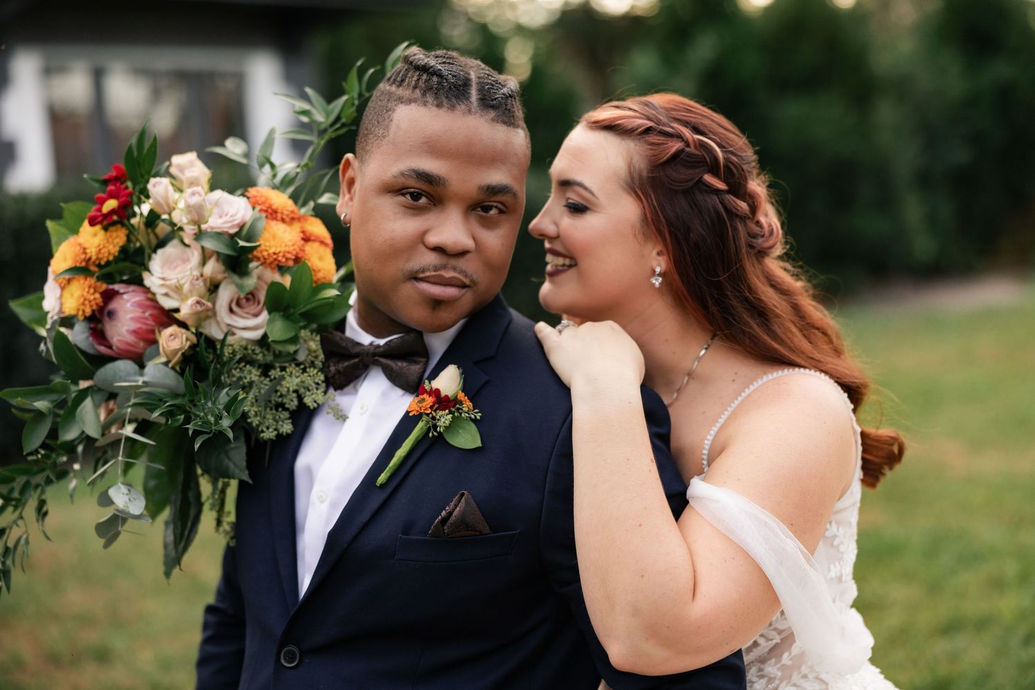 beautiful authentic wedding photo of couple in wedding attire in front of venue taken by photographer in orlando