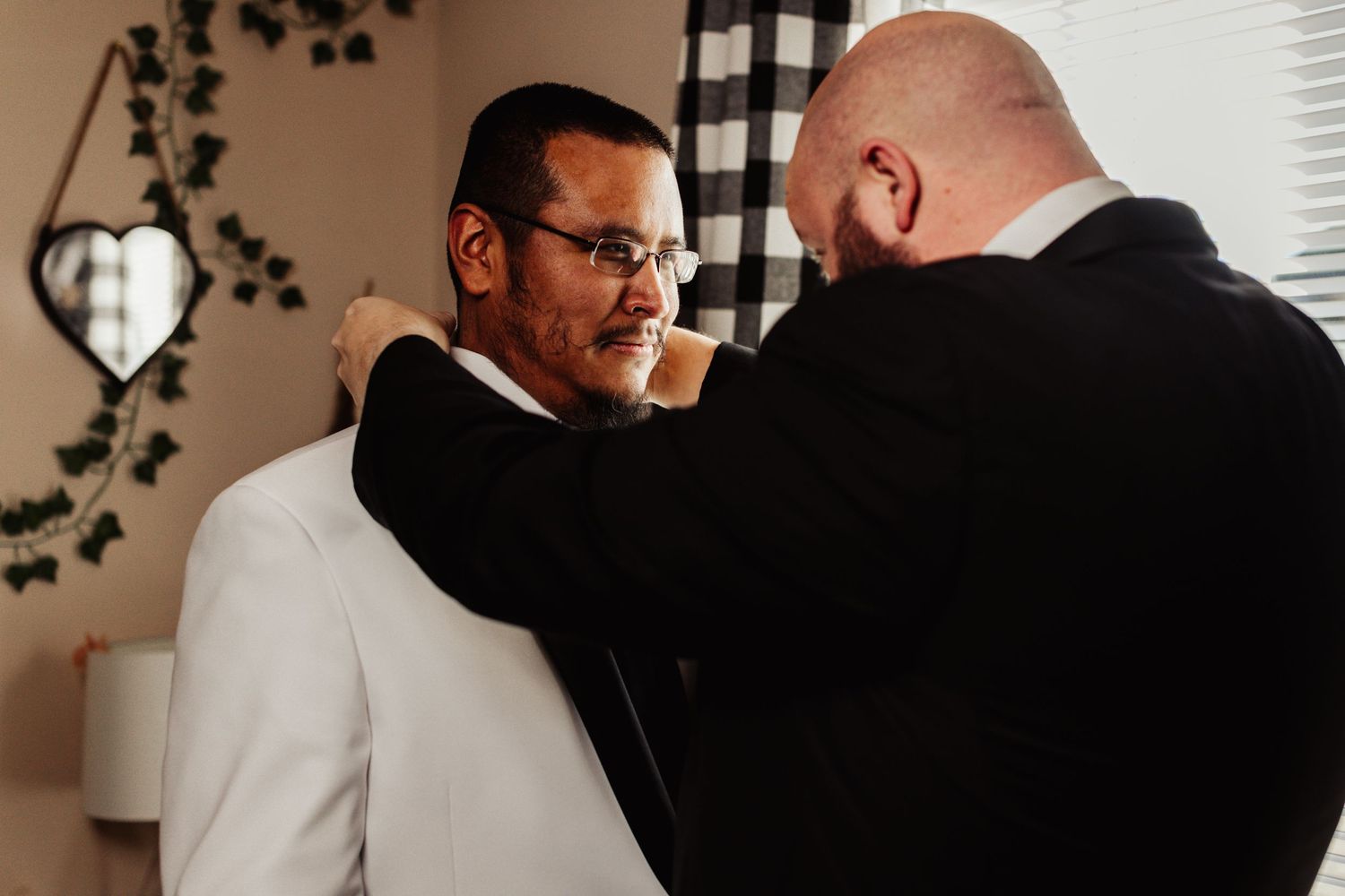 Fort Worth Wedding at the Stock Yards with golden lights and a groom with white tux and groomsmen dressed in black