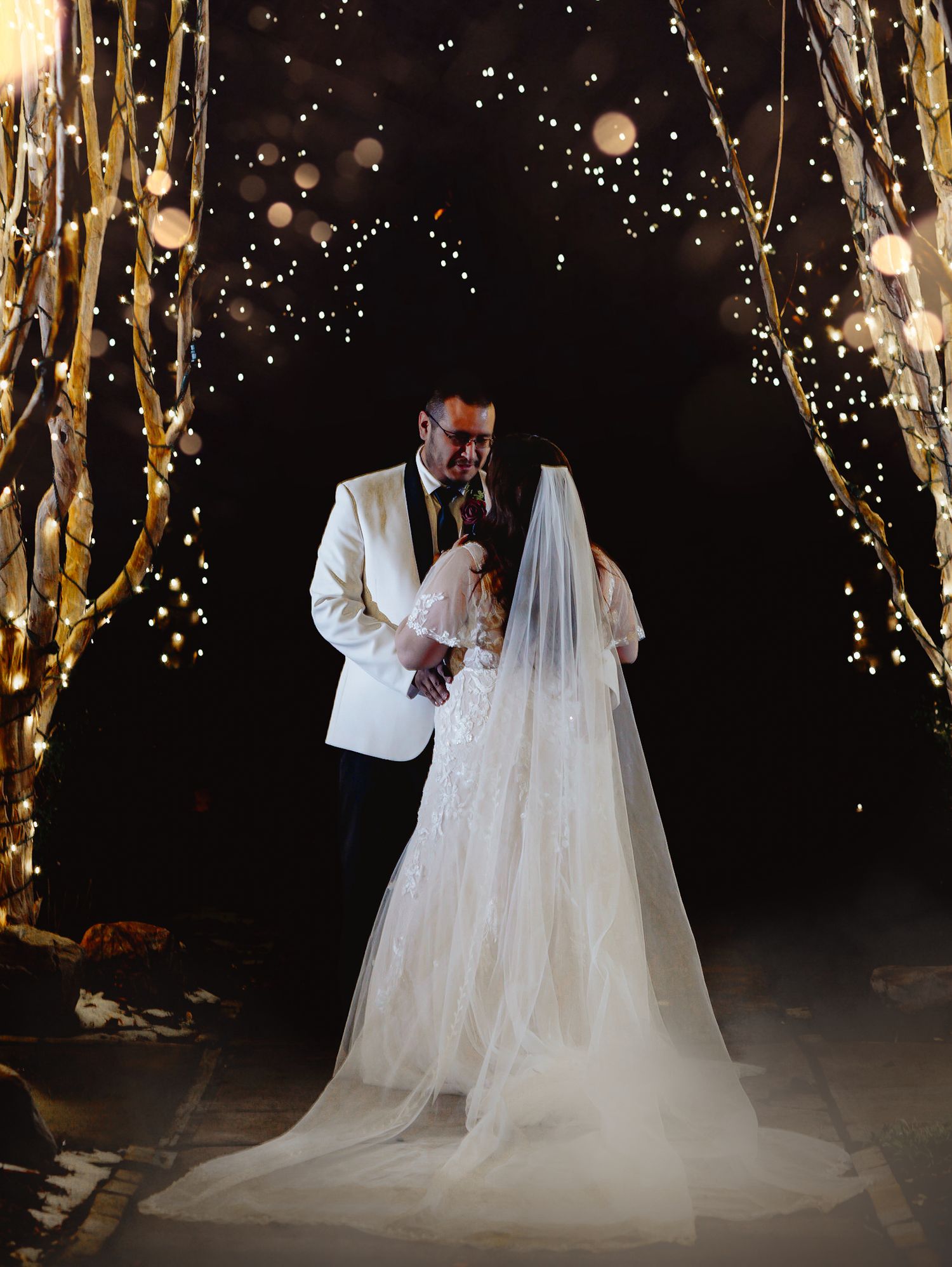 Fort Worth Wedding at the Stock Yards with golden lights and a white ivory dress and white tux