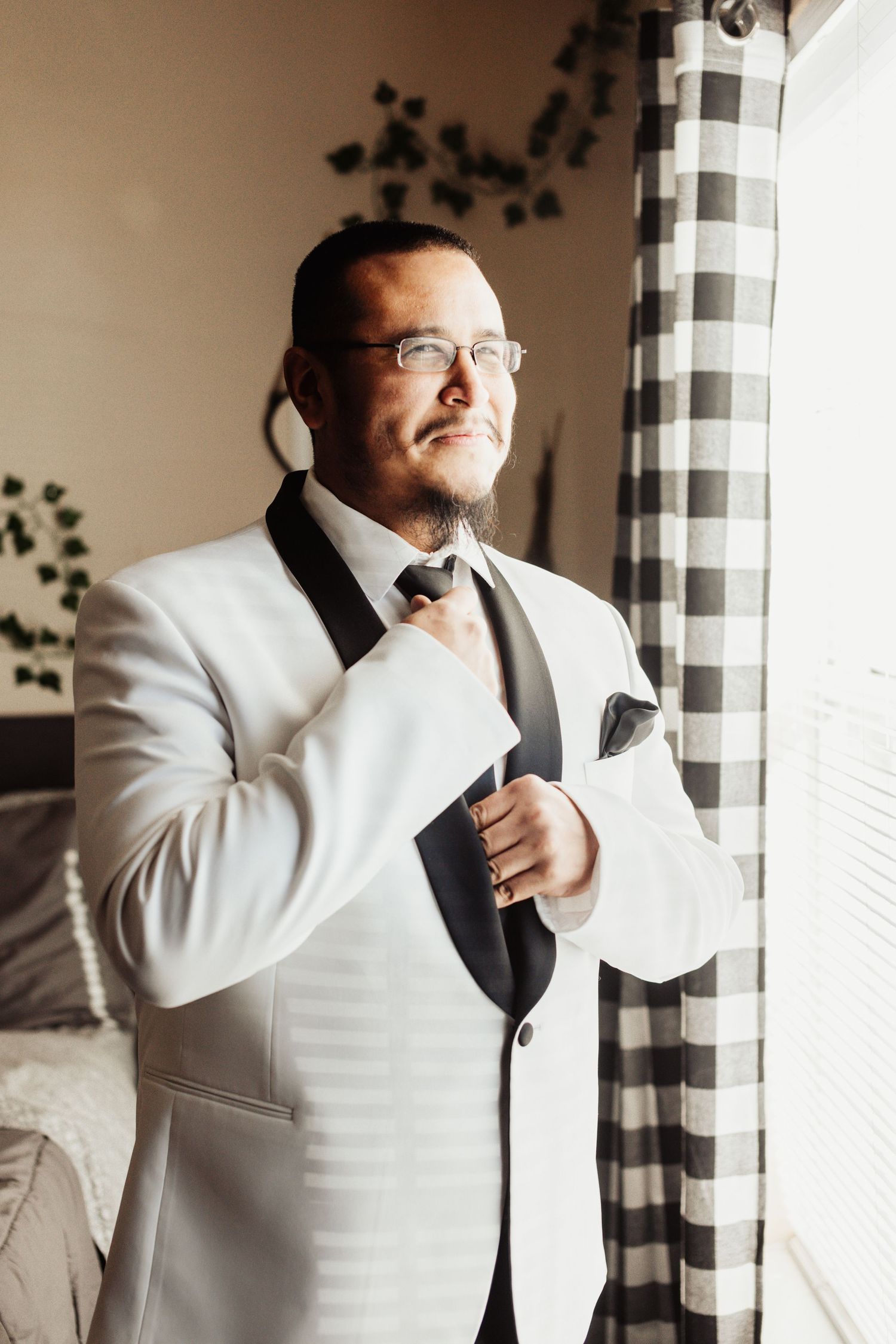 Fort Worth Wedding at the Stock Yards with golden lights and a groom with white tux and groomsmen dressed in black