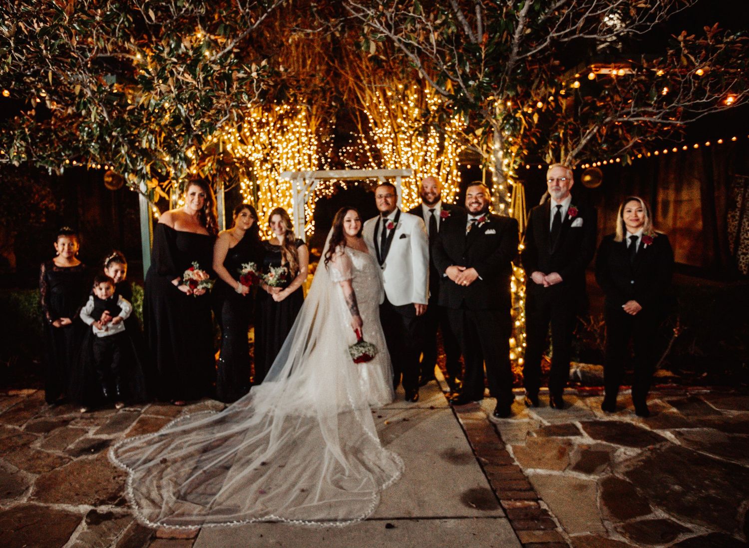 Fort Worth Wedding at the Stock Yards with golden lights and a white ivory dress and white tux