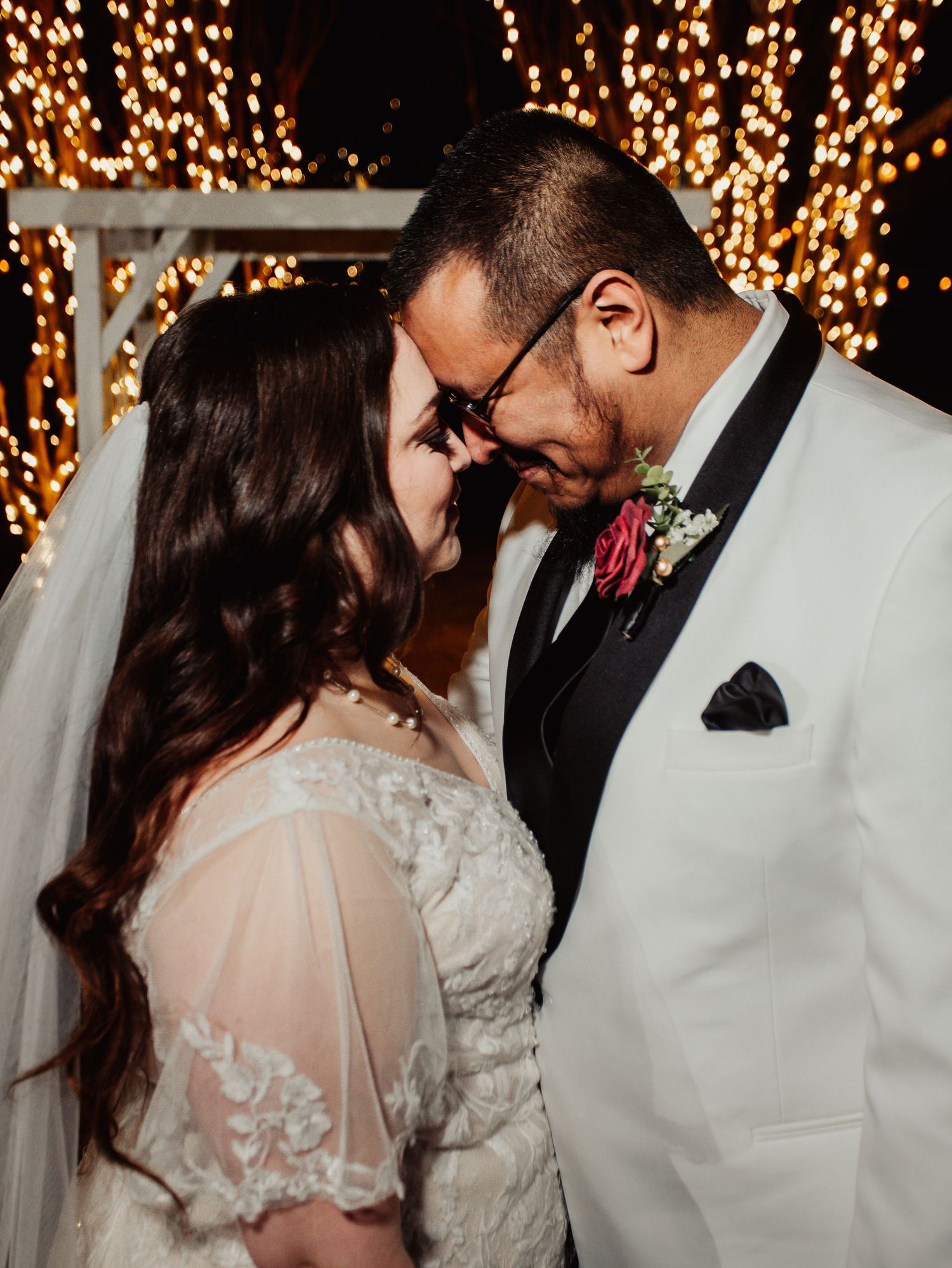 Fort Worth Wedding at the Stock Yards with golden lights and a white ivory dress and white tux