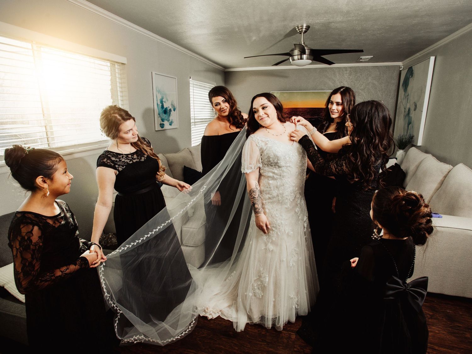 Fort Worth Wedding at the Stock Yards with golden lights and a white ivory dress and black brides maid dresses
