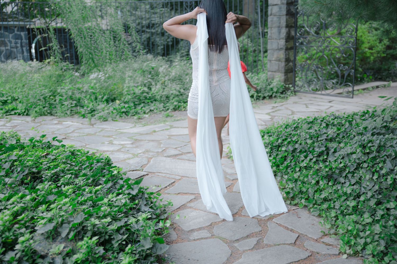 Elegant outdoor portrait of woman in luxury white dress. Professional photo. Garden. Gibraltar (Hugh Rodney Sharp Mansion) Delaware. Texas.