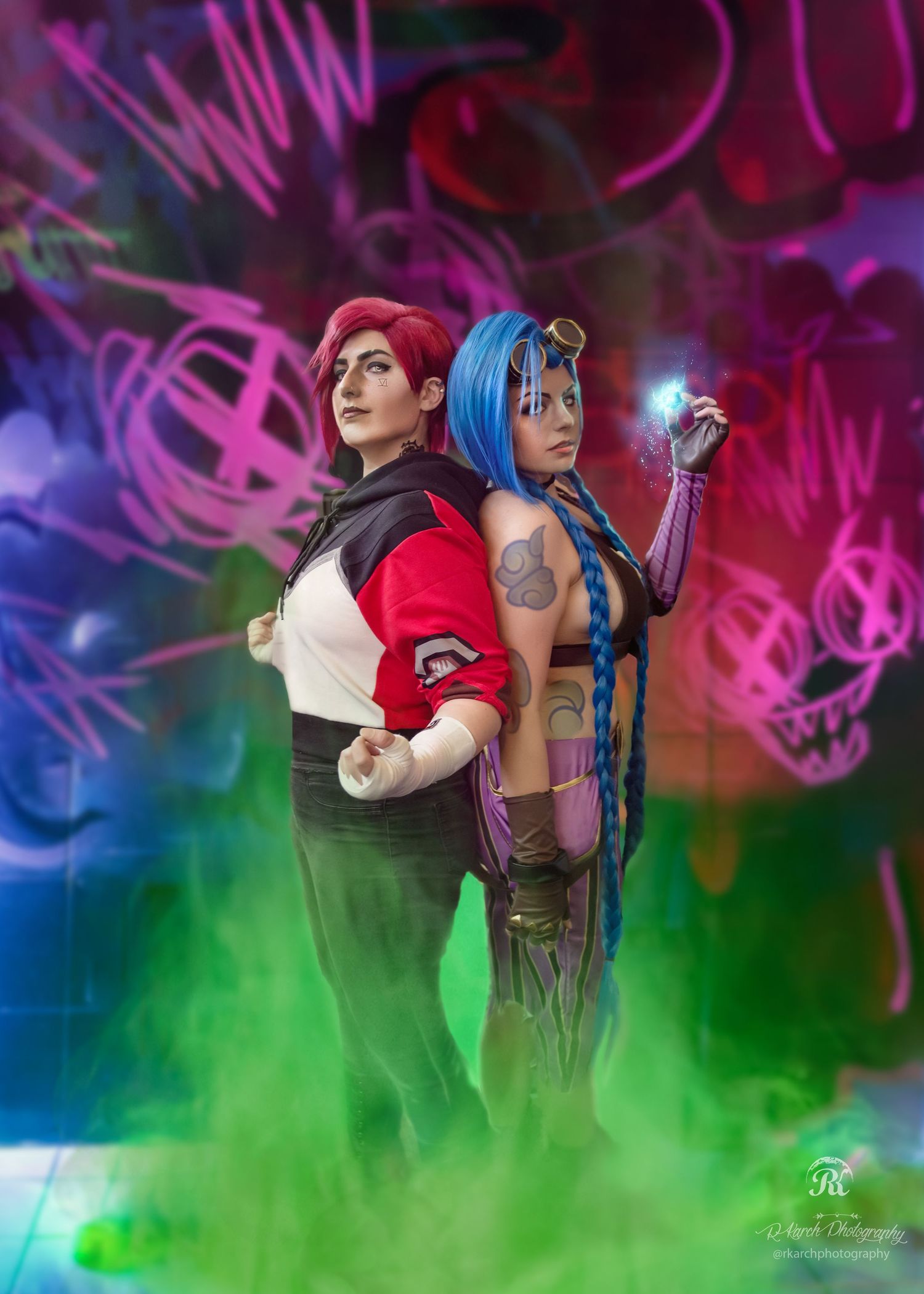 Two cosplay characters posing back-to-back with colorful neon graffiti background.