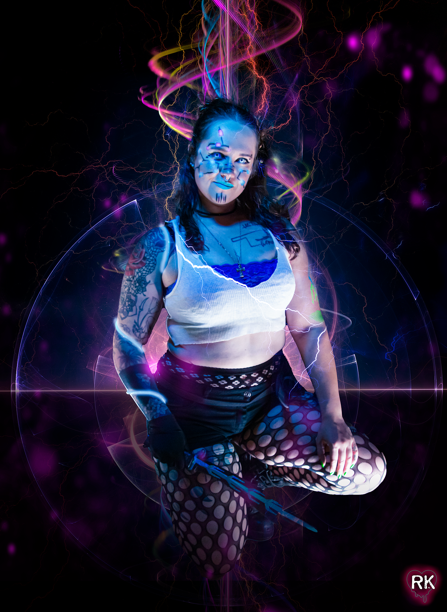 Artistic portrait with neon lighting effects showing figure in white top with glowing blue makeup.