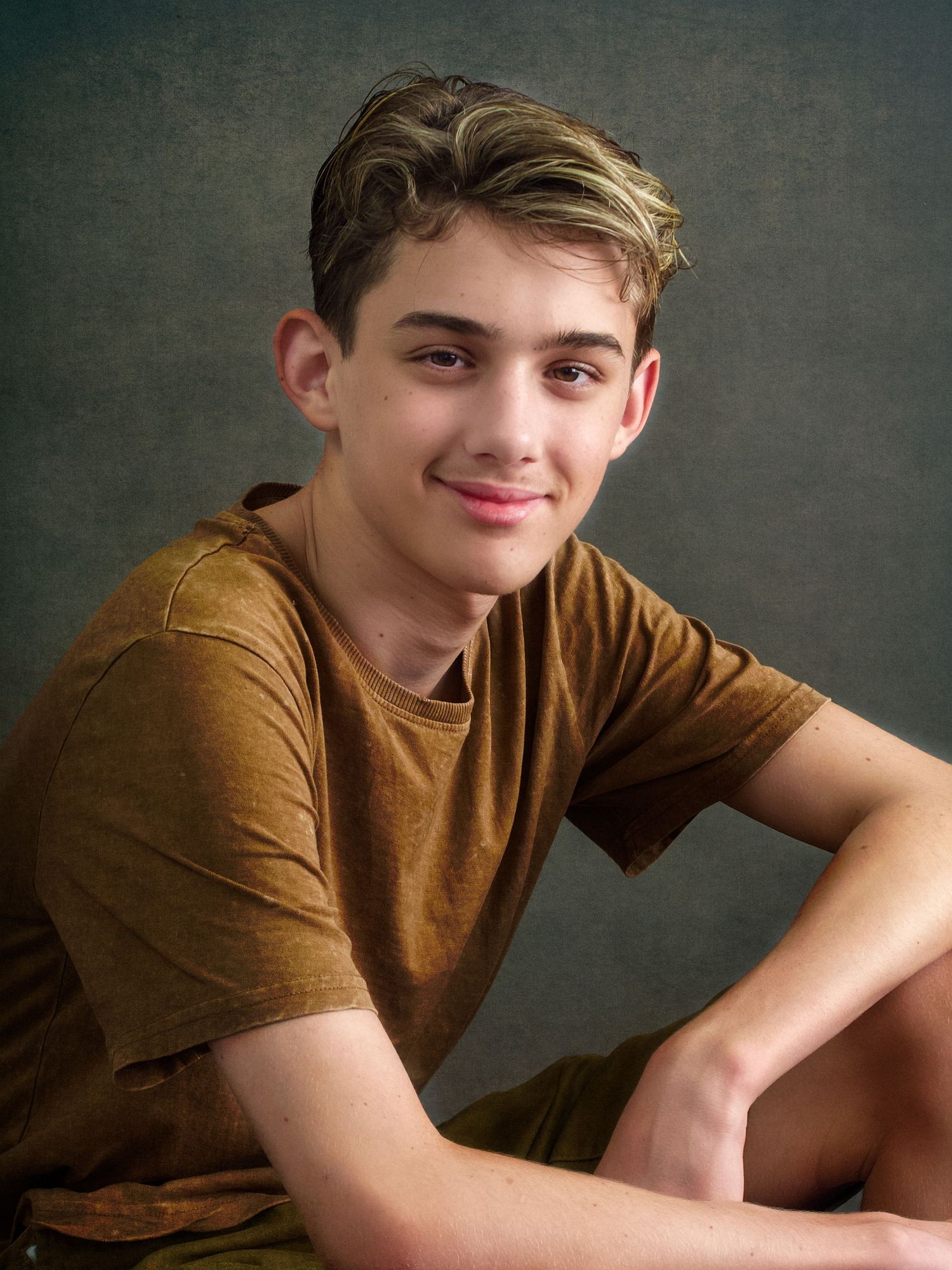 Teen Male casual portrait sitting wear a light tan tshirt