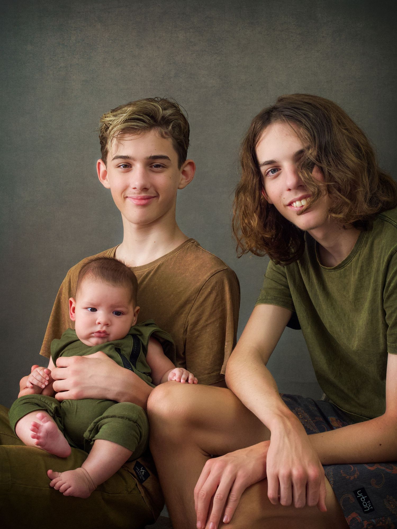 Three brothers casual sitting portrait wearing earthy tone colours