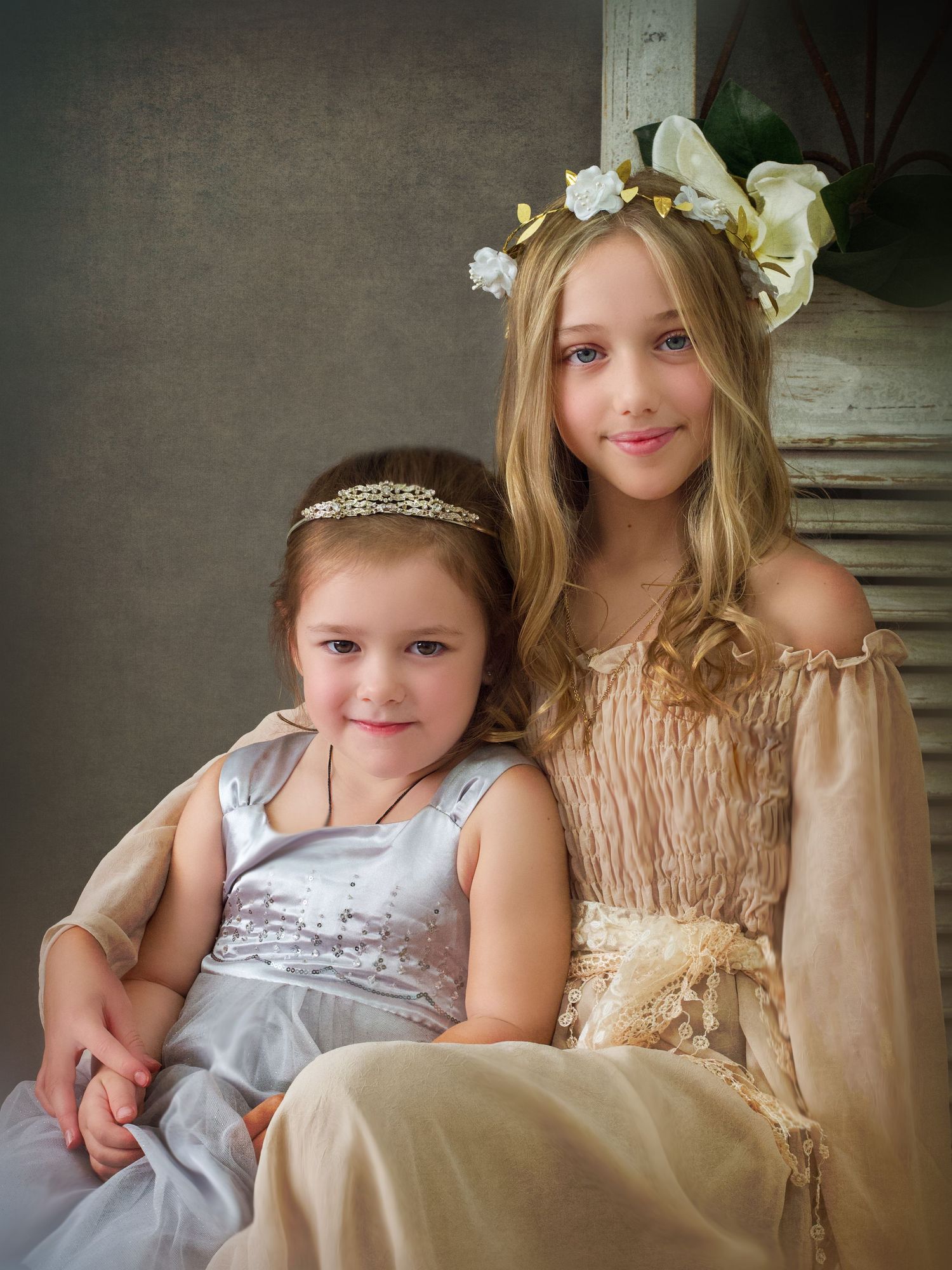 Two sister casual portraits wearing grey and pink with crowns