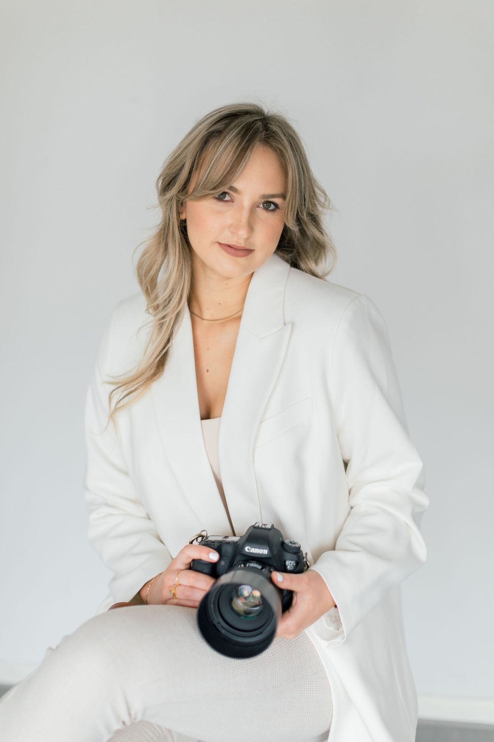Leah Anne Kopp brand photo sitting on a stool