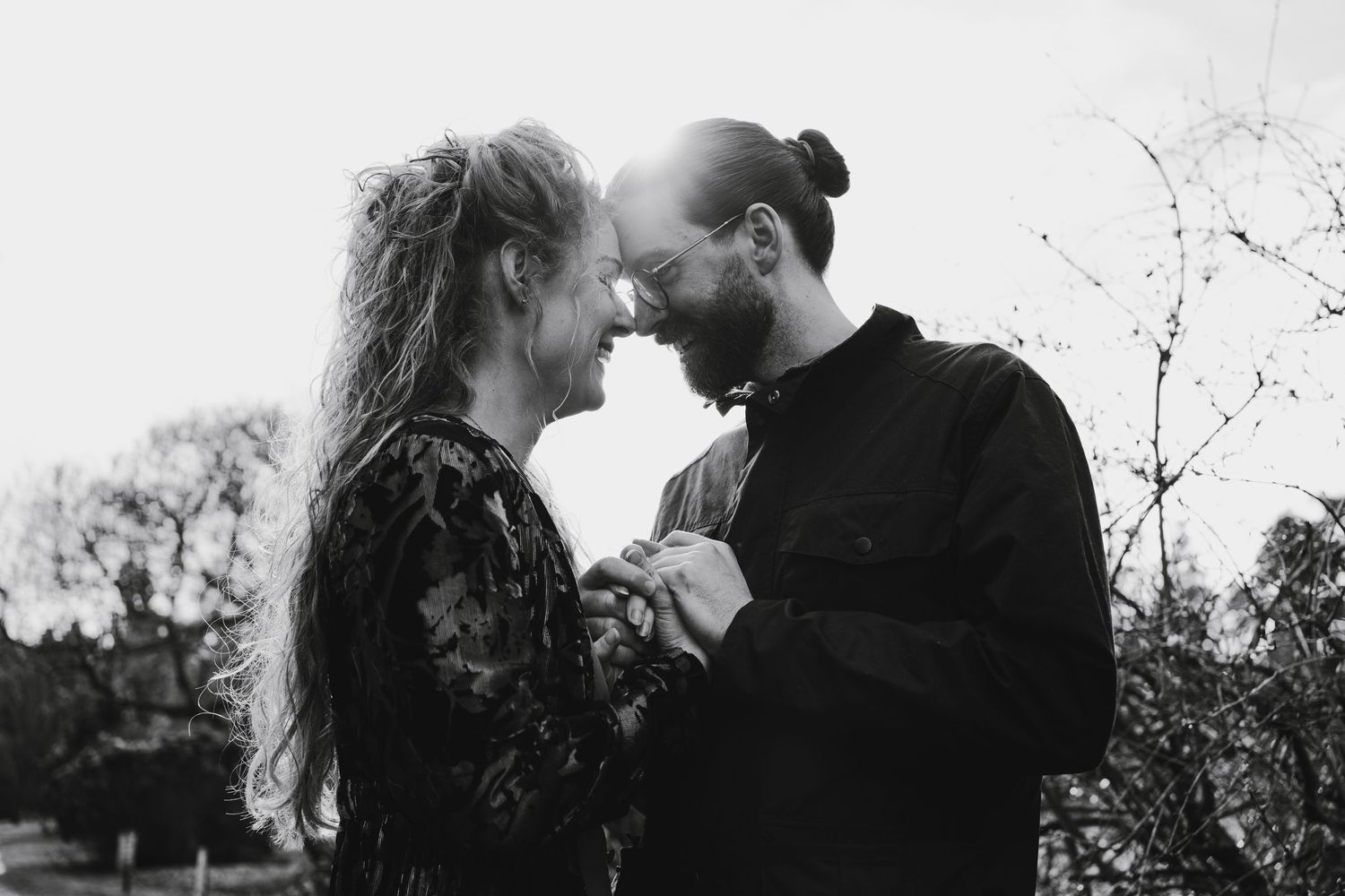 couple holding hands with heads together