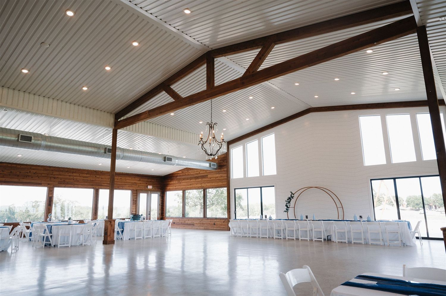 Modern reception venue with vaulted ceilings, exposed beams and large windows.