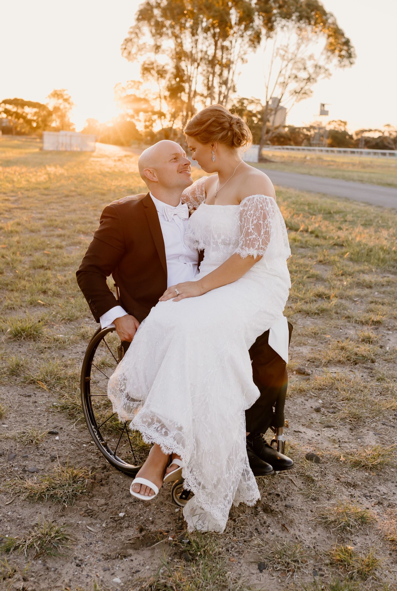 A romantic sunset wedding portrait with a couple sharing an intimate moment outdoors.