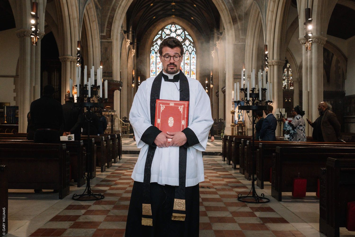 Vicar in church at a funeral
