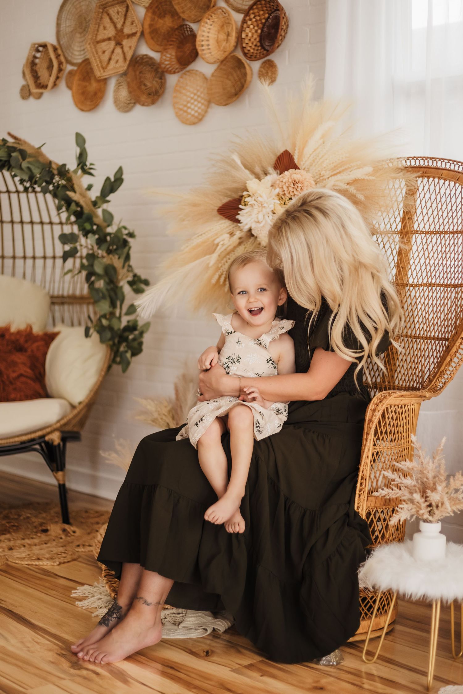 A peacock chair and boho decor create a warm, natural aesthetic in a bright interior setting.