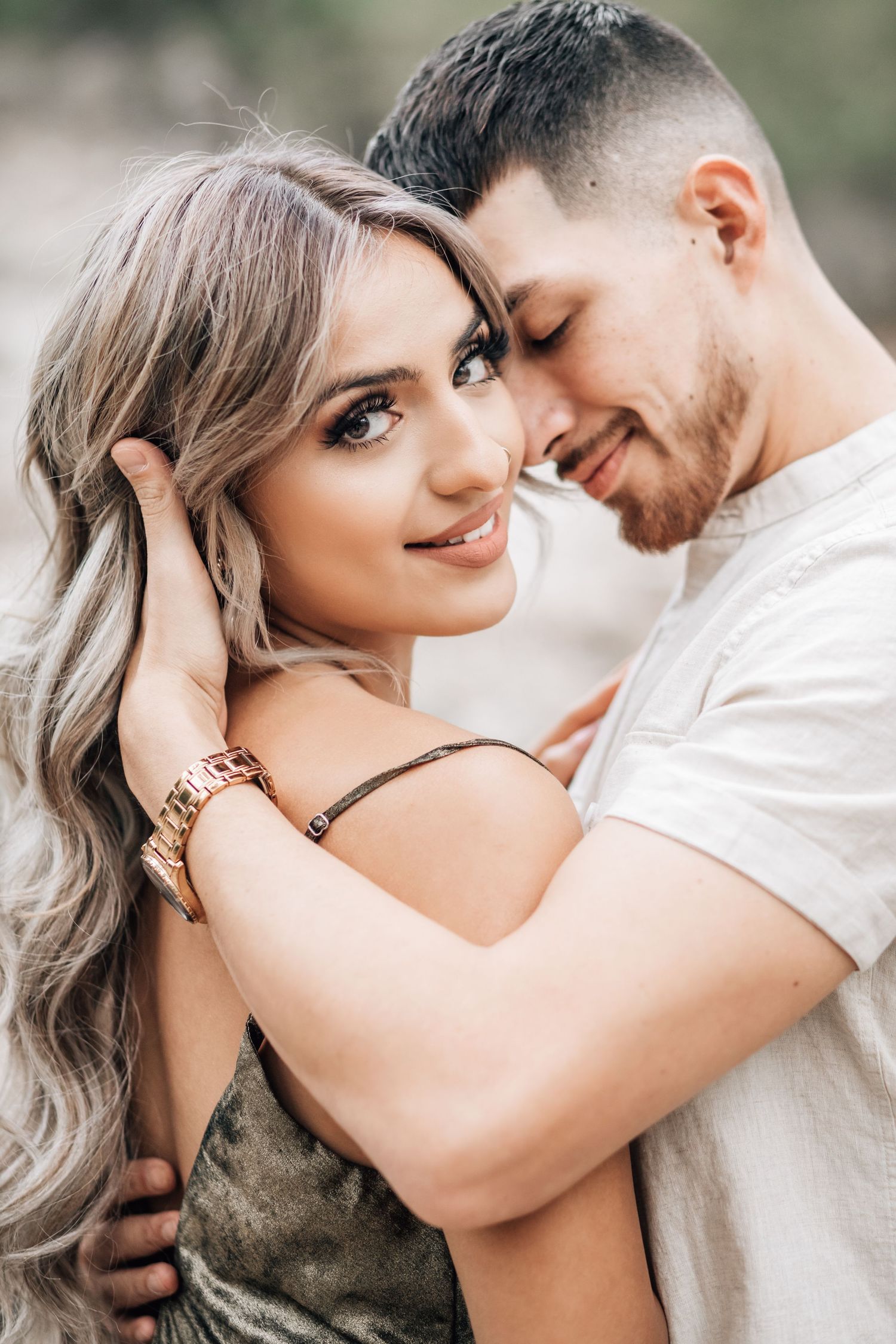 Tucson couples portrait of a man and woman embracing closely with soft, warm natural light.
