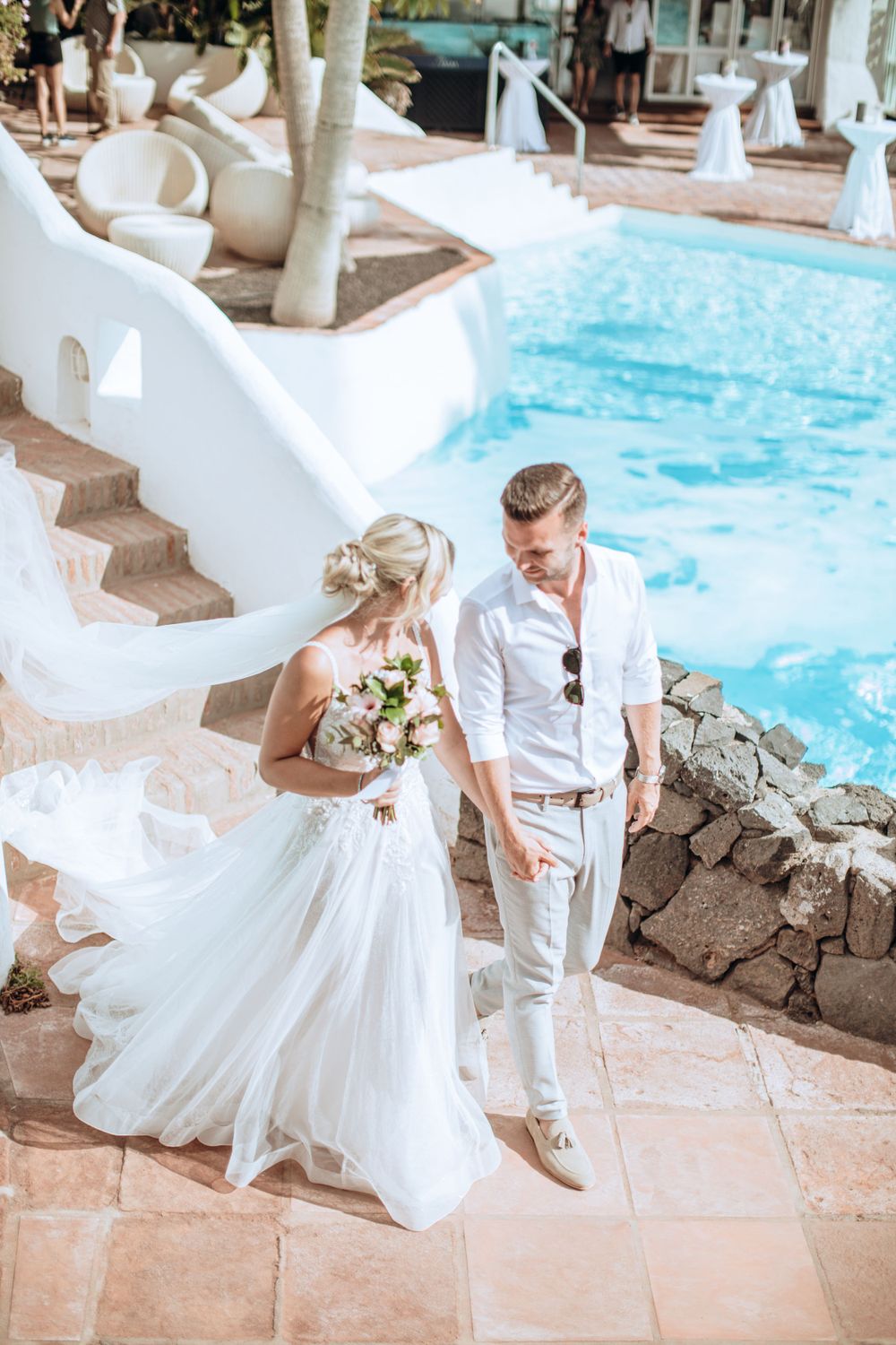 Bride and groom starring at eachother while walking towards the ceremony area.