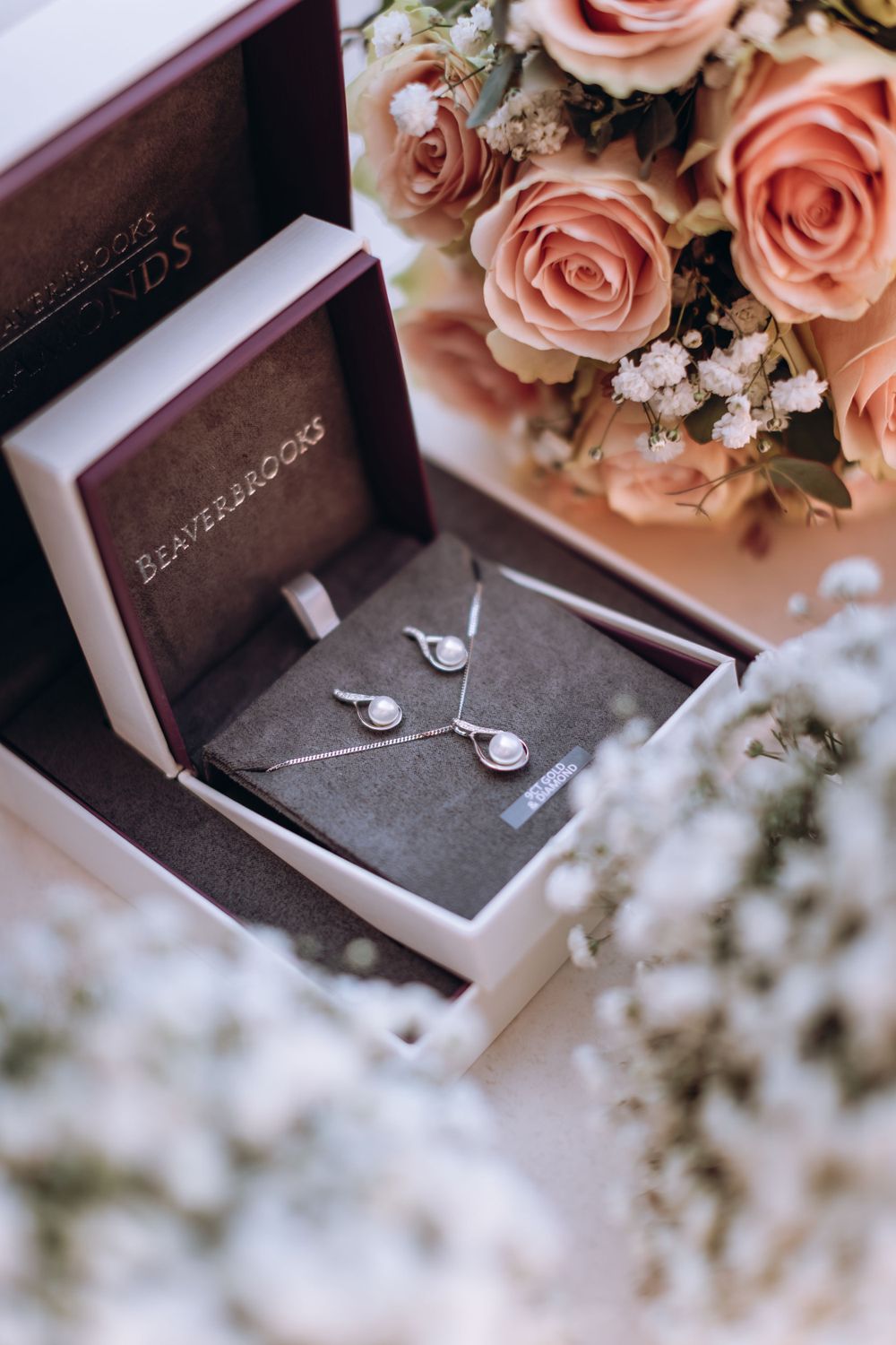 Wedding jewelry box details surrounded by wedding flower bouquets.