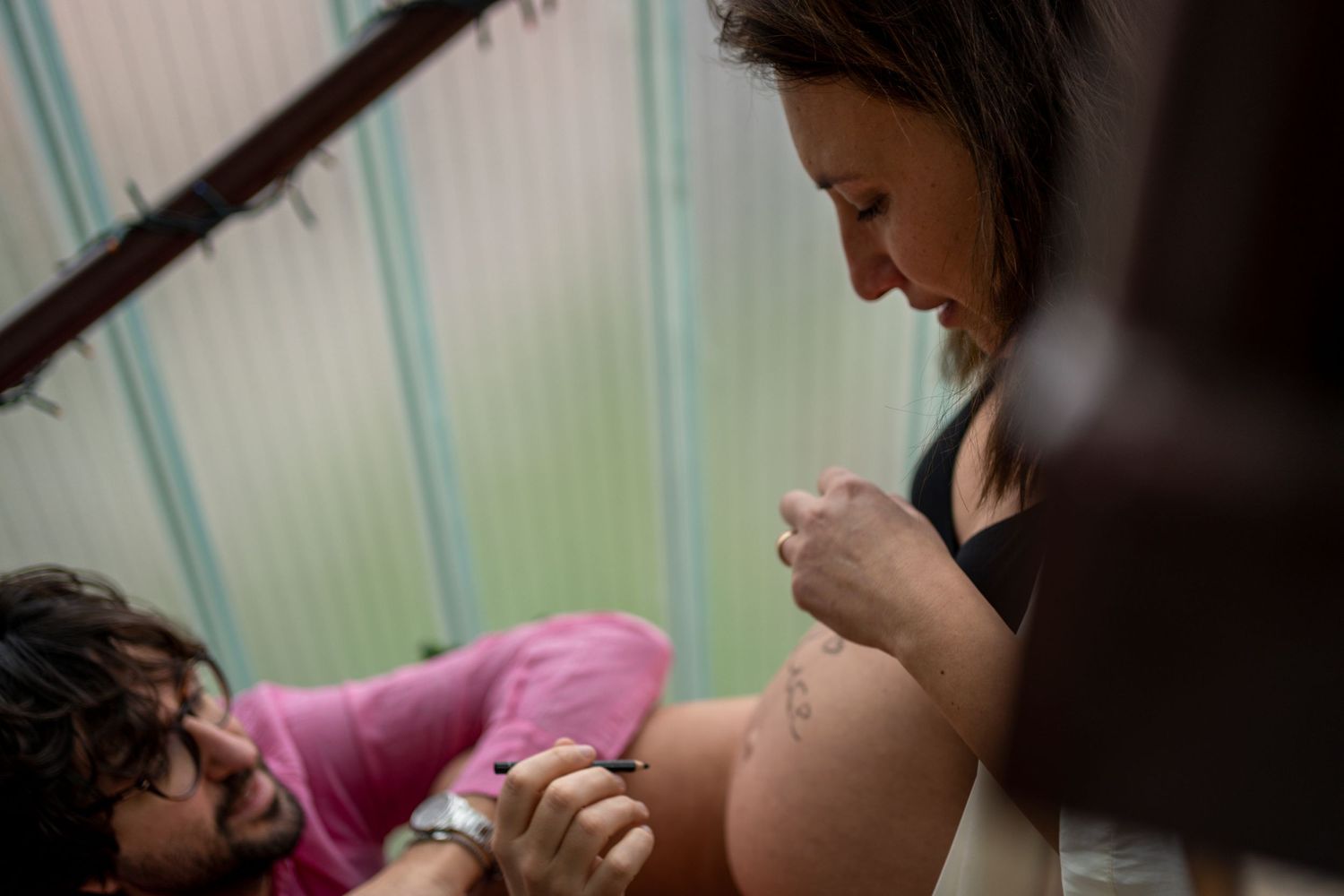 An intimate pregnancy photography session with natural lighting.
