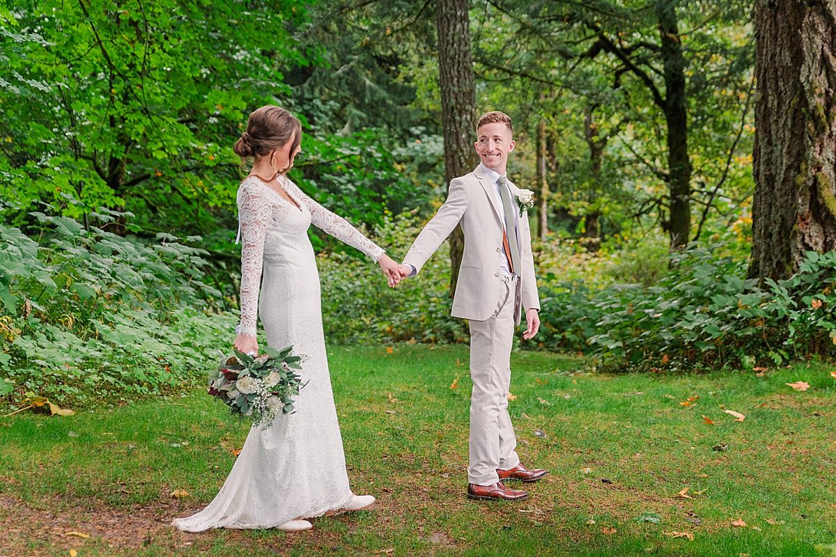 Bride and groom walking together around lake captured by Indianapolis Wedding Photographer