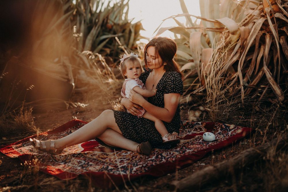 Candid family lifestyle photography session in a tropical garden setting.