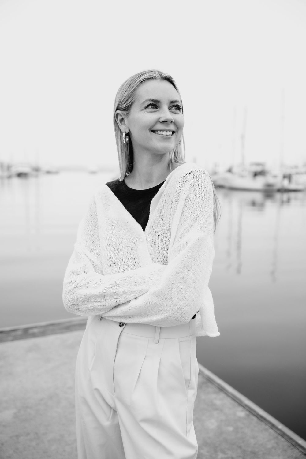Black and white portrait of stylish outfit against marina setting with boats.  Branding photography. headshot. Newport Rhode island