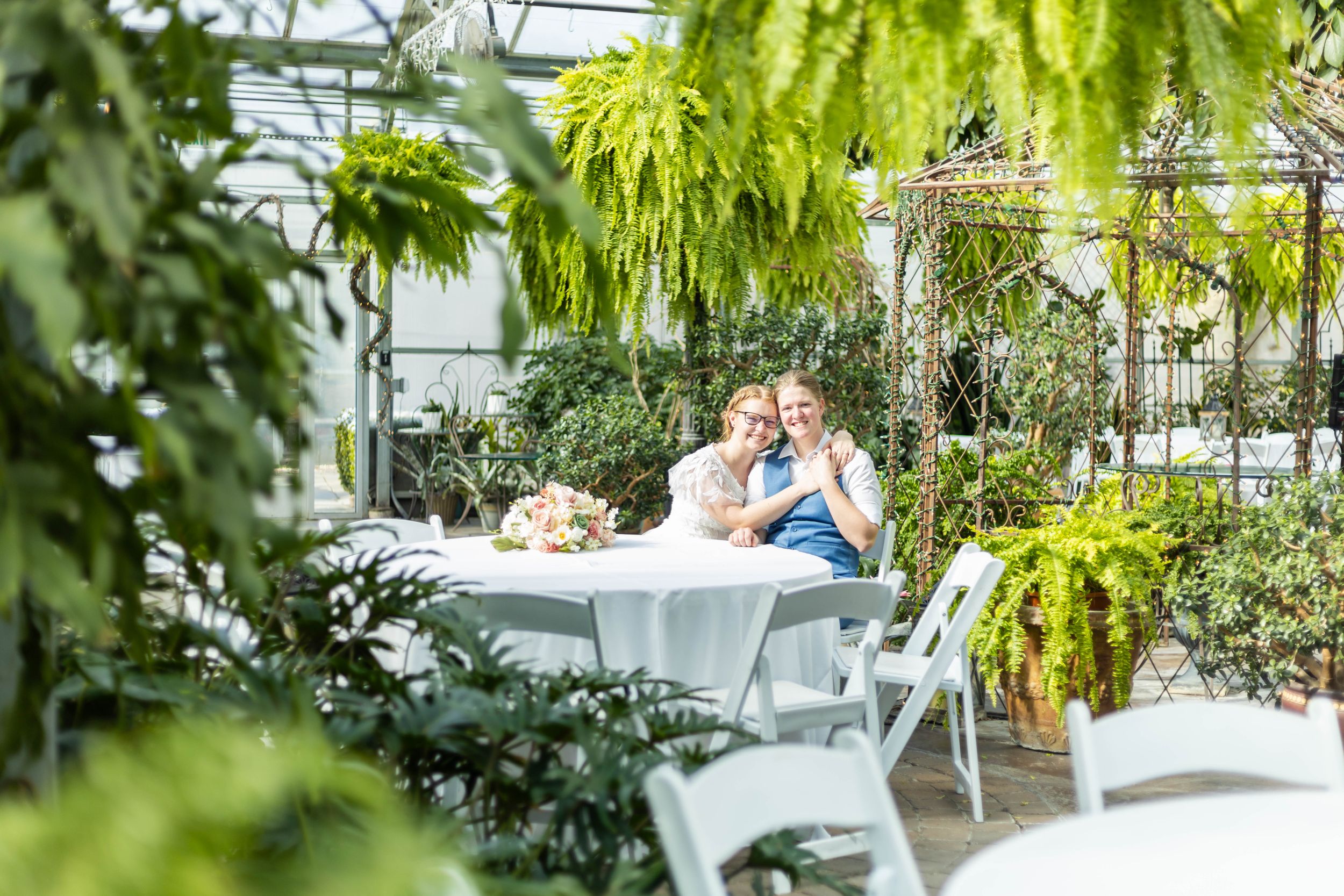 A couple at a table at the Le Jardin wedding venue
