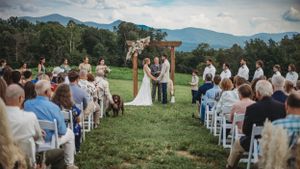 Scenic mountain view of wedding guests seated for an outdoor ceremony.