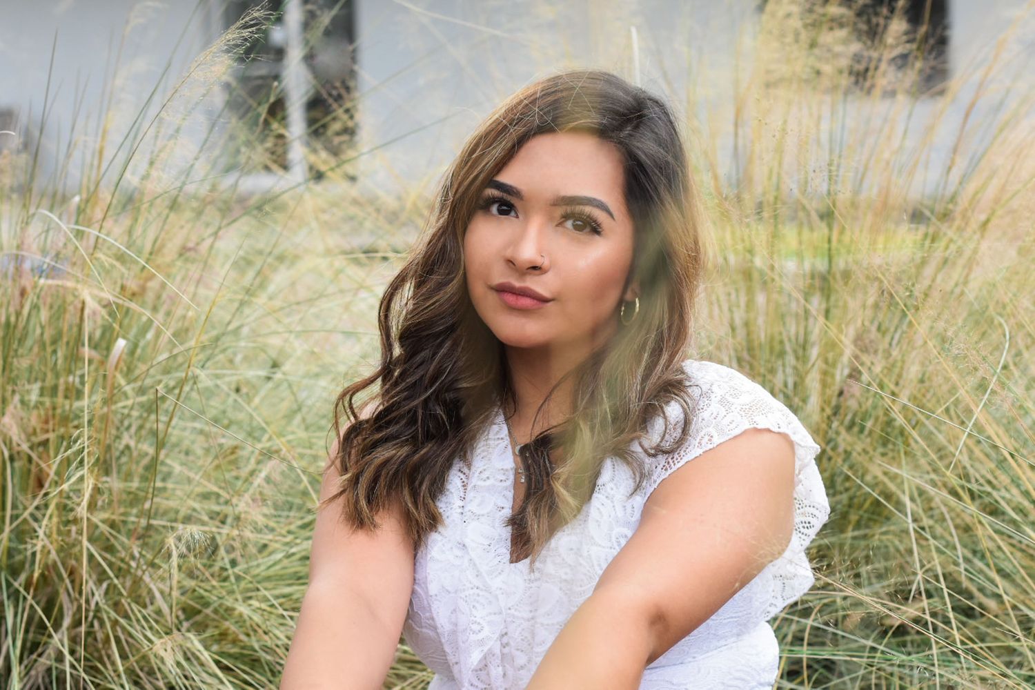 Portrait in tall grass with soft natural lighting.