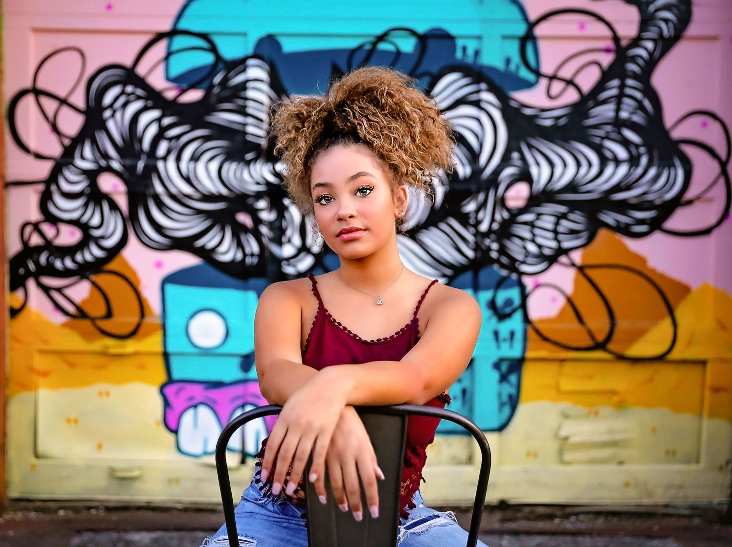 A stylish portrait against a colorful graffiti wall with a retro boombox design.