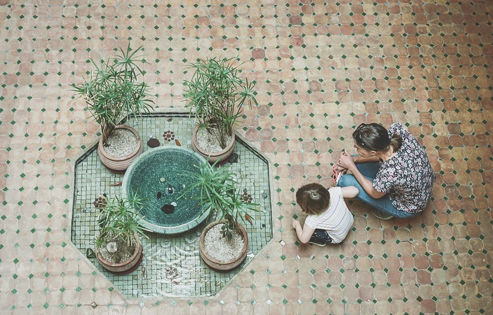 35mm film photo of woman and child with fountain birds eye angle