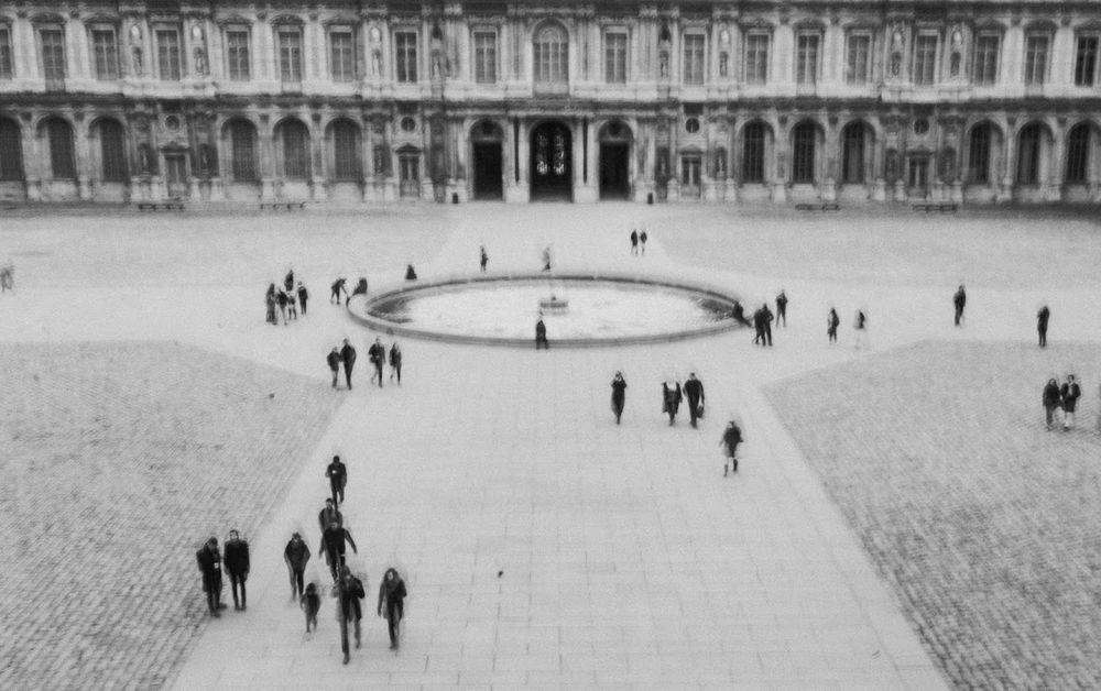 35mm black and white motion blur image of people on the street from above Paris France