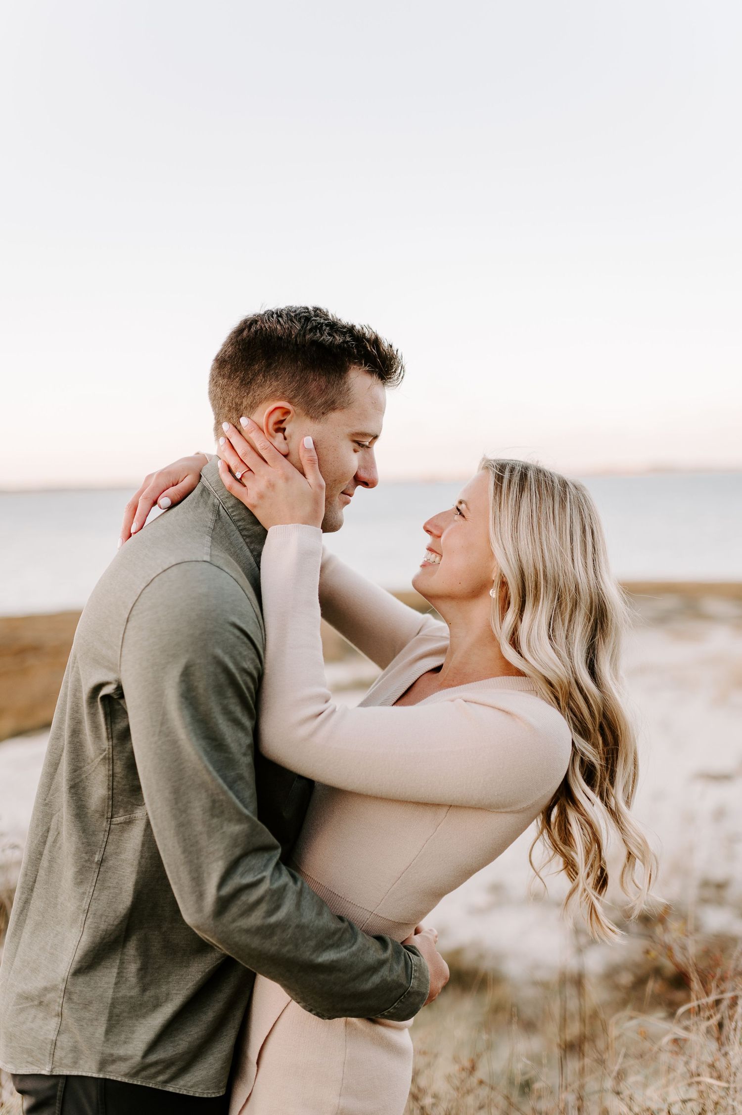 Couple sharing tender moment during sunset photoshoot in outdoor setting.