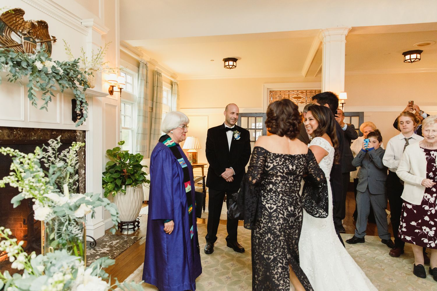 Wedding celebration candid moments captured in an elegant indoor venue with warm lighting.
