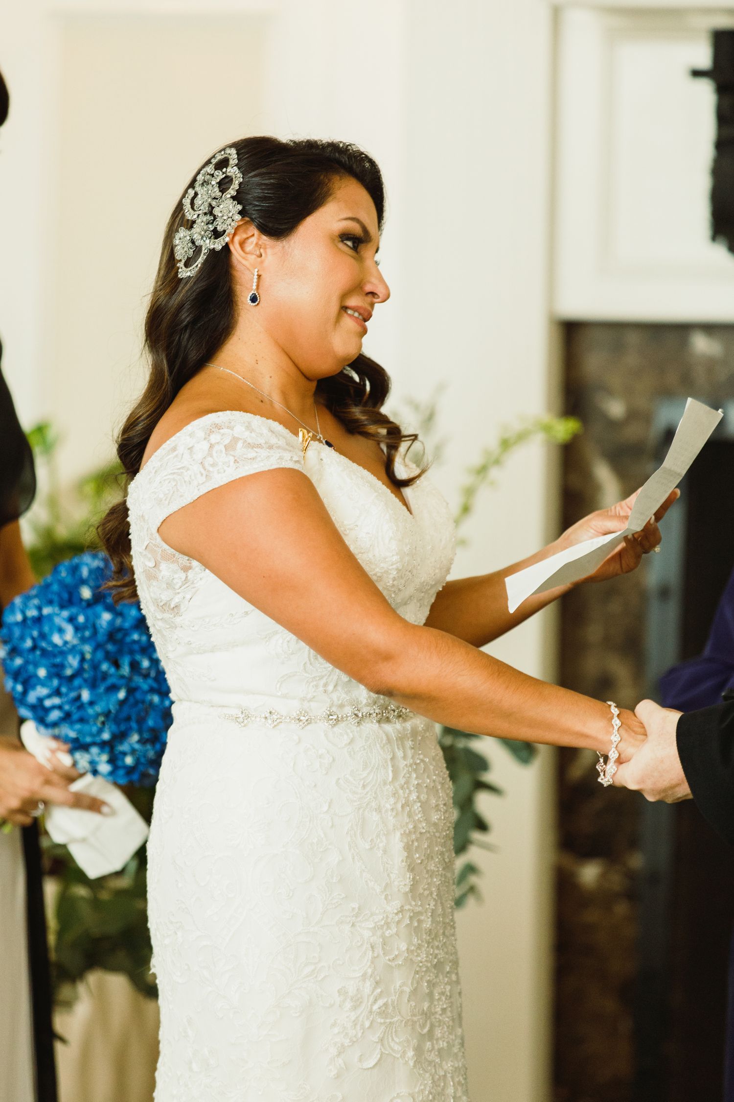 A bride in a white lace dress shows joyful expressions during a wedding ceremony sequence.