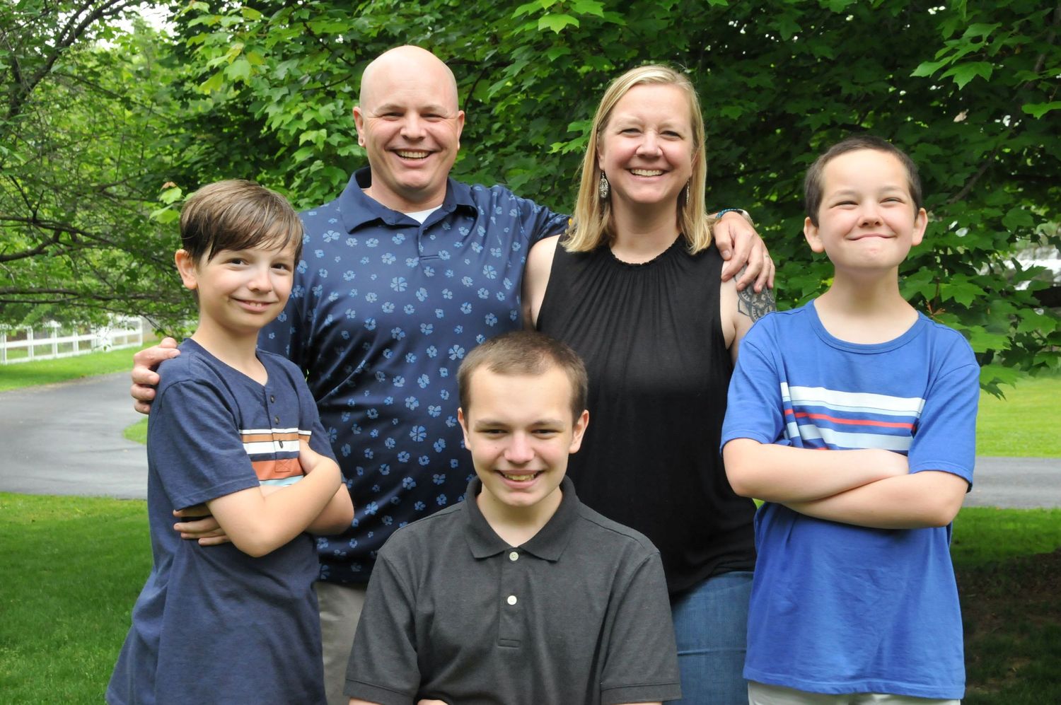 Family photo outside with parents and three boys