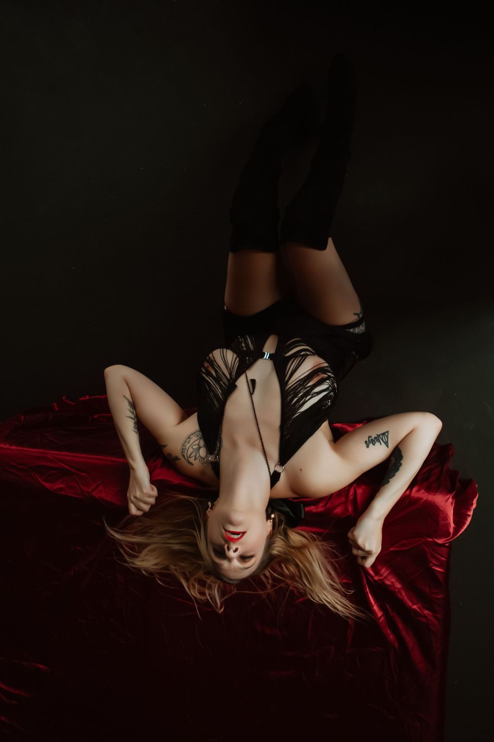 boudoir image on red silk sheets