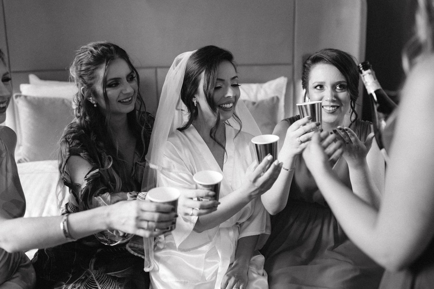 A candid moment of laughter and joy during wedding preparations.