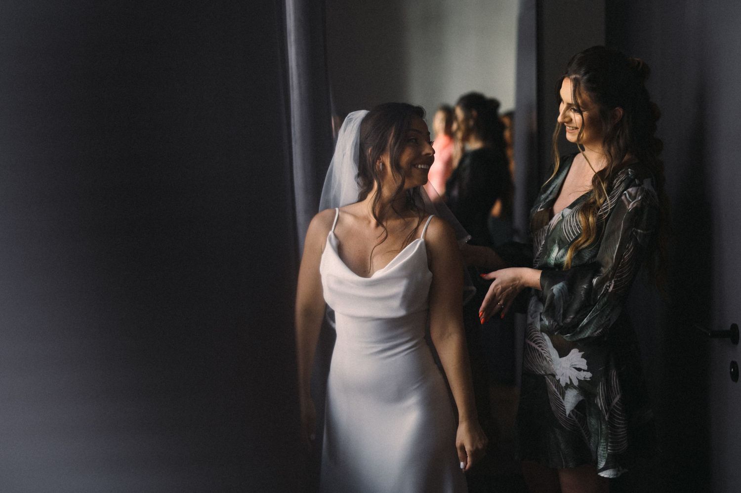 An intimate moment captured during wedding day preparations in natural light.