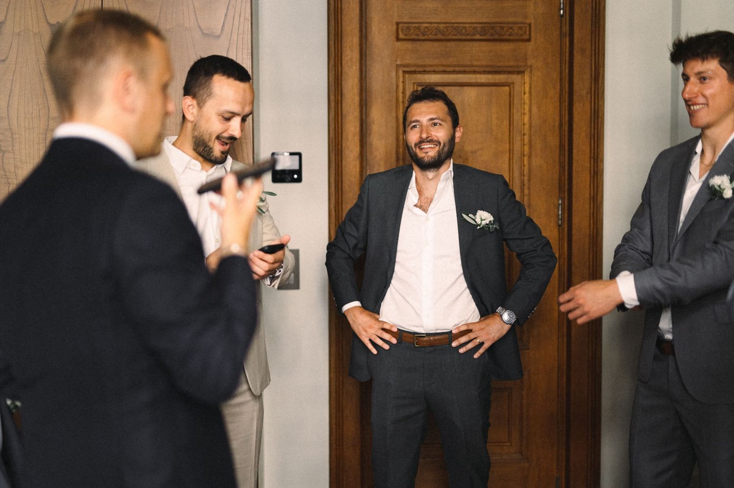 Groomsmen sharing laughs and candid moments before the wedding ceremony.