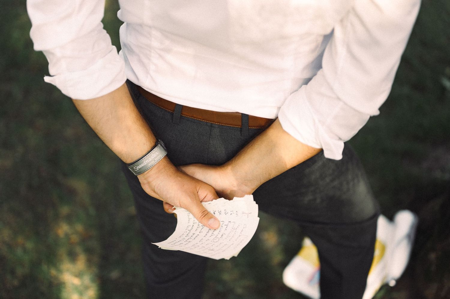 Close-up of hands shuffling playing cards during outdoor event.