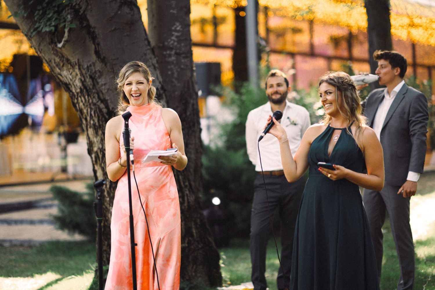 Group performs speeches during outdoor evening celebration.