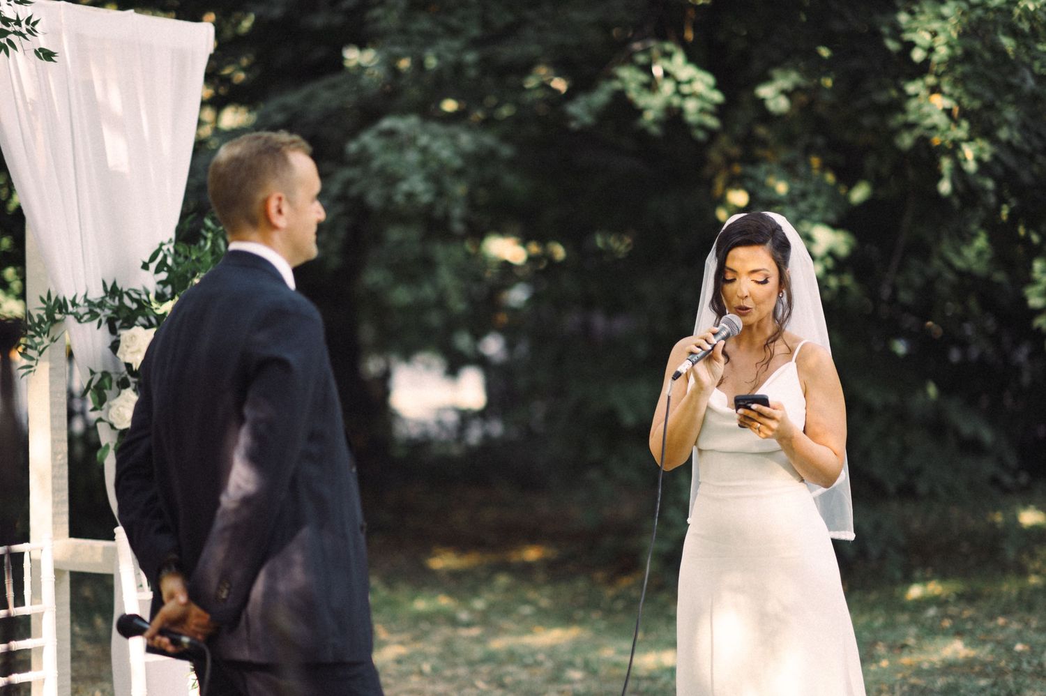 An emotional moment during an outdoor garden wedding ceremony.