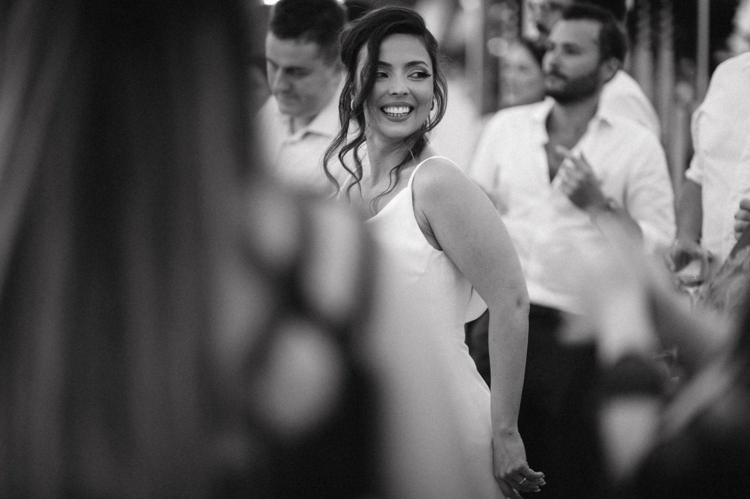 Black and white photo of celebratory moment at indoor party venue.