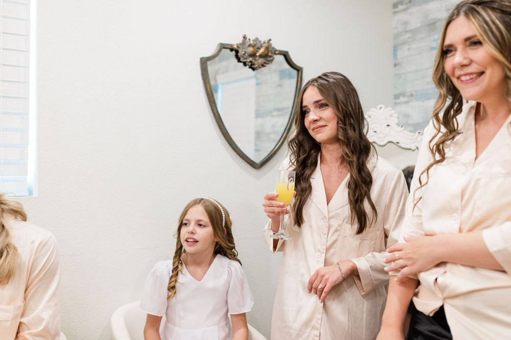 A joyful group gets ready in silk robes during wedding preparations.
