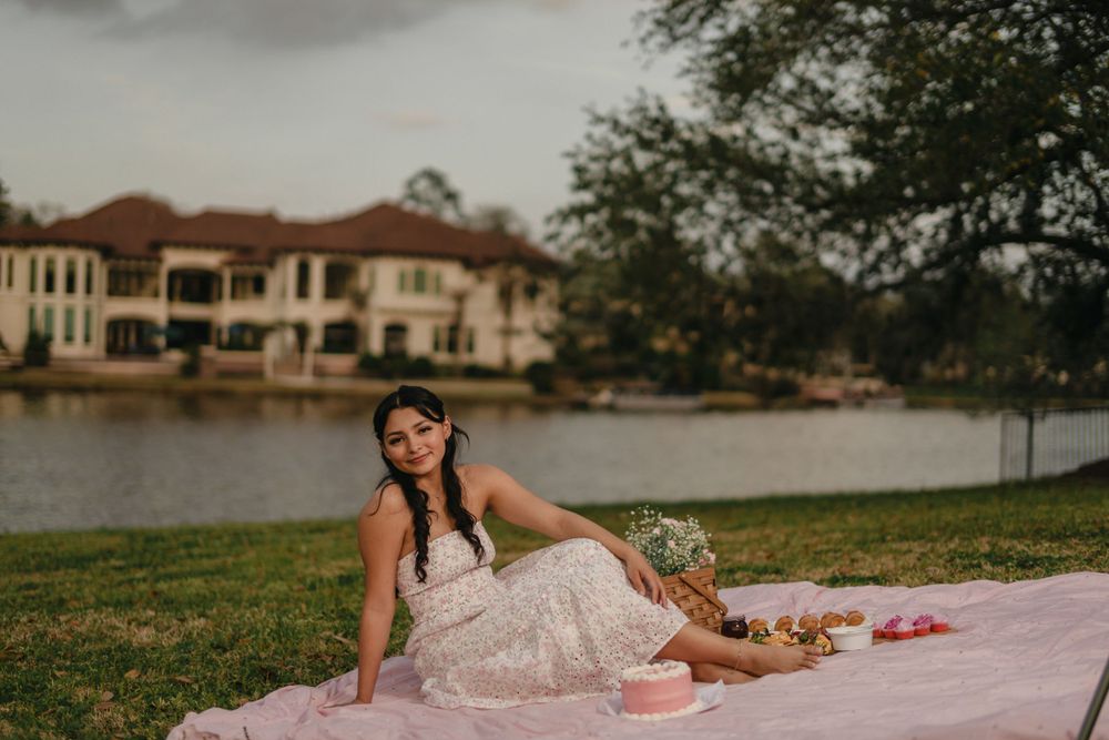 Romantic lakeside photo shoot with pink blanket and elegant styling.