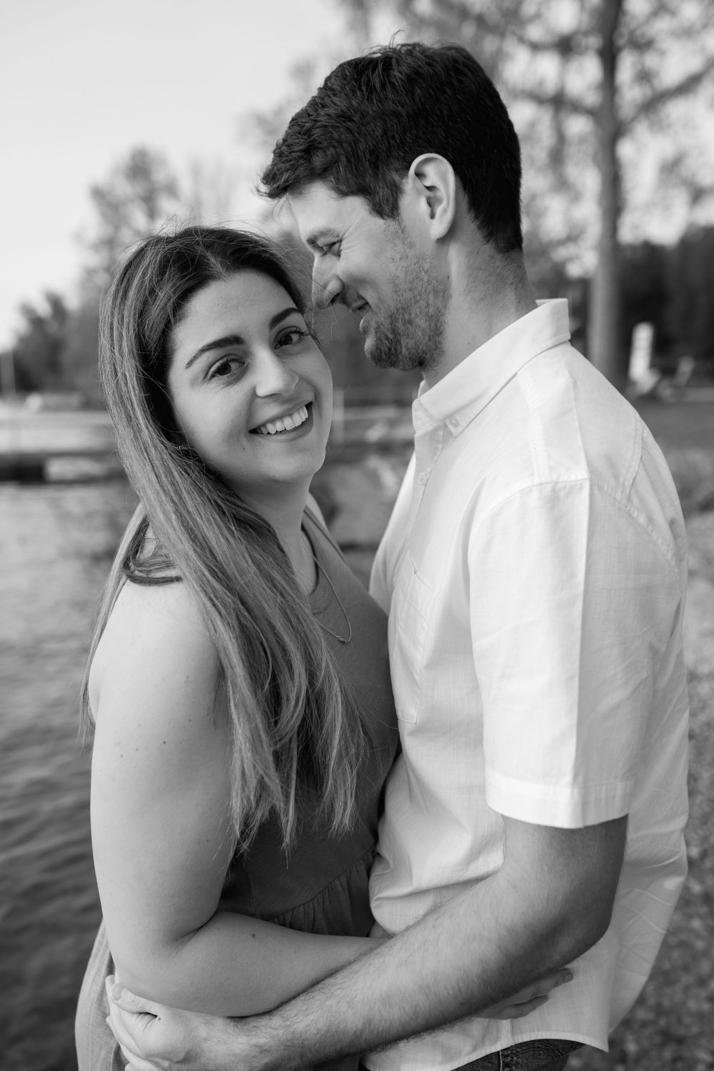 A couple shares joyful moments together by the water's edge.