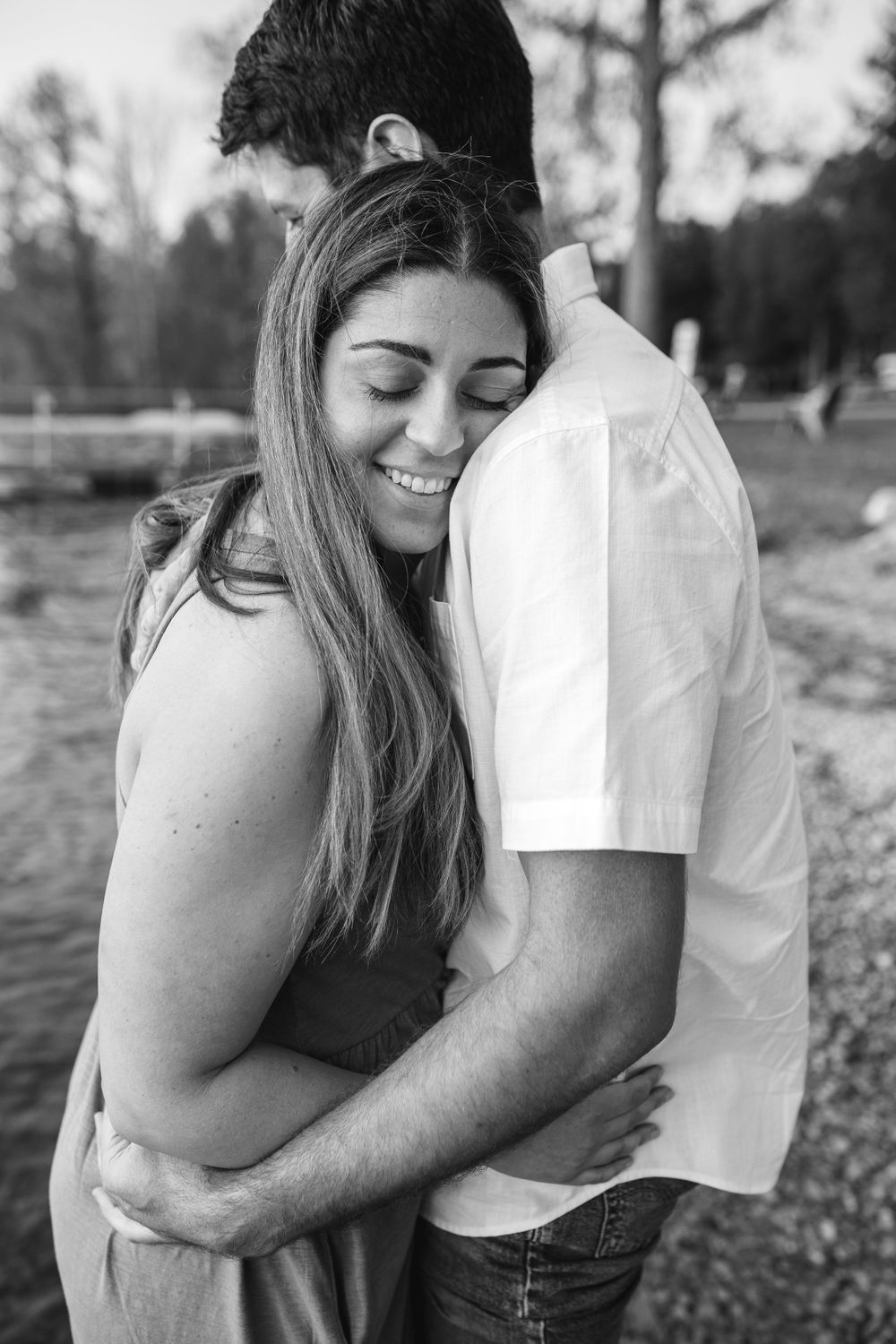 A series of tender moments captured in black and white photos along a waterfront setting.