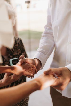 Close-up of hands exchanging rings during ceremony.