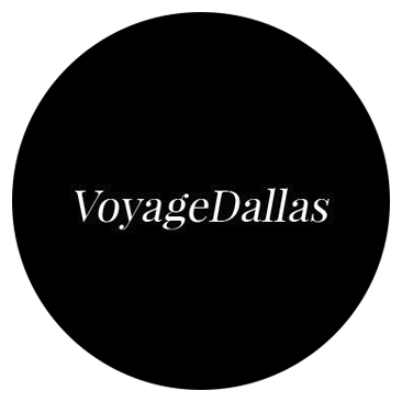 Black circular logo design for VoyageDallas in elegant white typography.